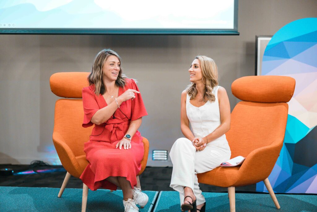 Professional photo of Lauren Kirk and Sarah Cincotta giving a presentation at the 2023 BDM Summit.